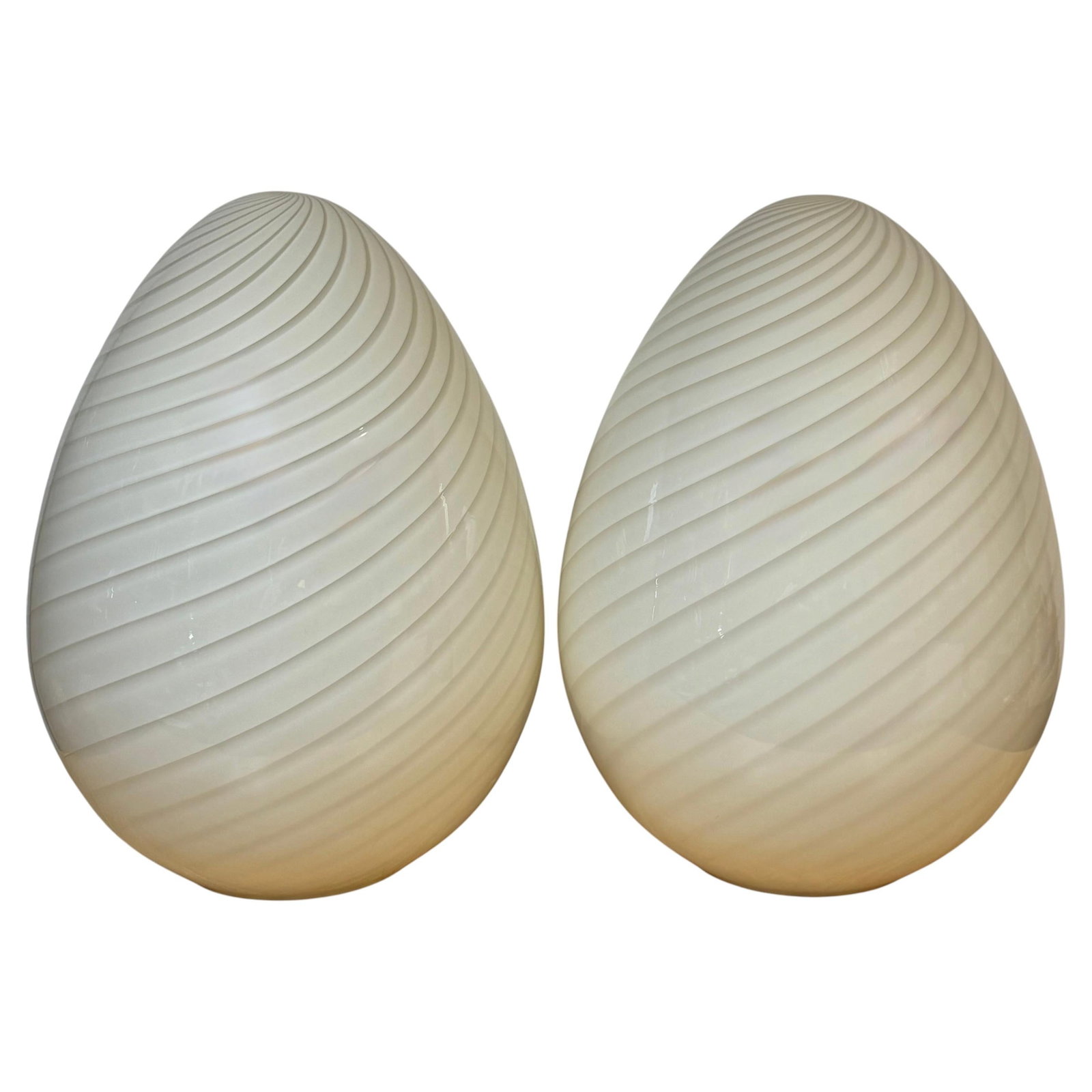 Set of 2 Murano Glass Spiral Ribbed Egg Lamps: Set of 2 Murano Glass Spiral Ribbed Egg Lamps This pair of monumental Murano glass egg lamps, crafted in Italy during the 1980s, features handblown opaque white lattimo glass with a dramatic spiral ri