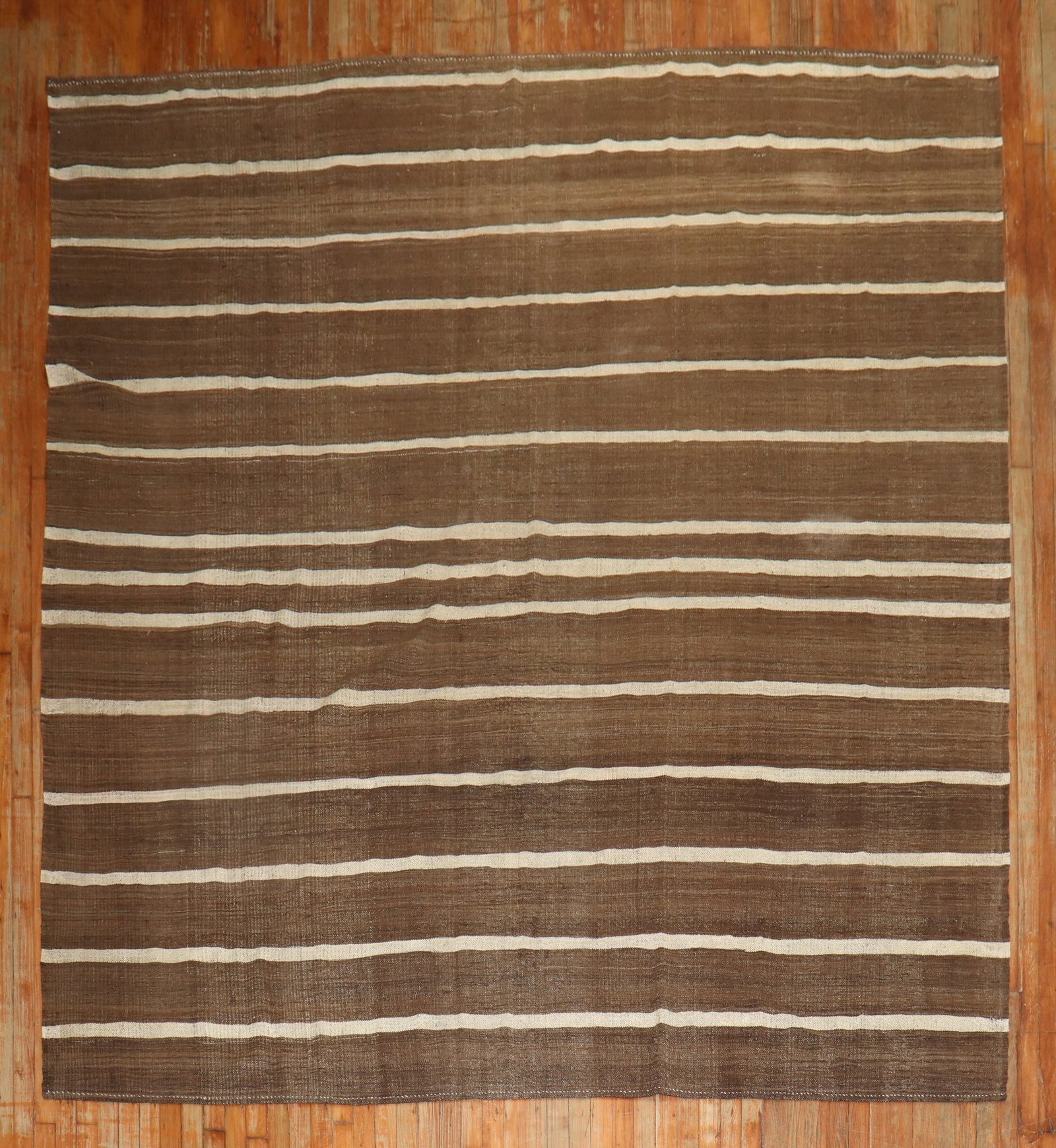 8' 7" x 10' 4" Turkish Brown and Cream Kilim Rug: 8' 7" x 10' 4" Turkish Brown and Cream Kilim Rug Mid 20th century Turkish kilim in a brown and cream striped design. This pre-owned room-size rug offers a classic flat-woven look with a versatile pale
