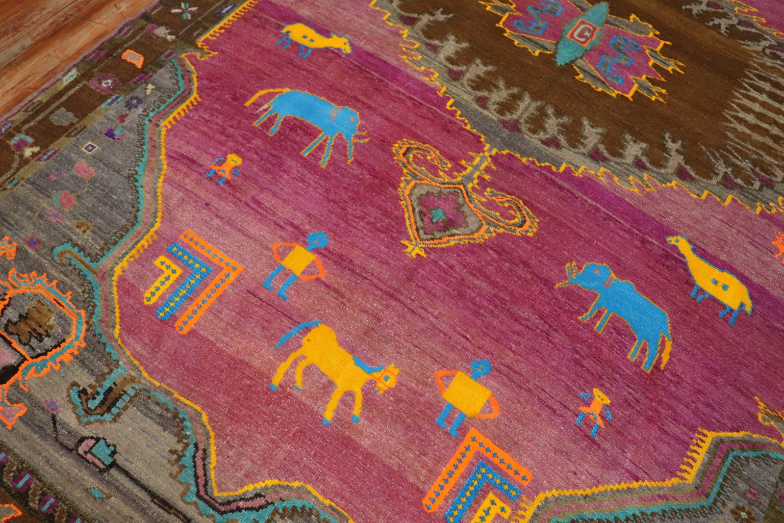 7' 9" x 13' 8" Turkish Kars pictorial rug animal human motif: 7' 9" x 13' 8" Turkish Kars pictorial rug animal human motif One-of-a-kind Turkish Kars pictorial room rug featuring a whimsical animal and human figurative motif on a fuchsia ground. Dating to the mi