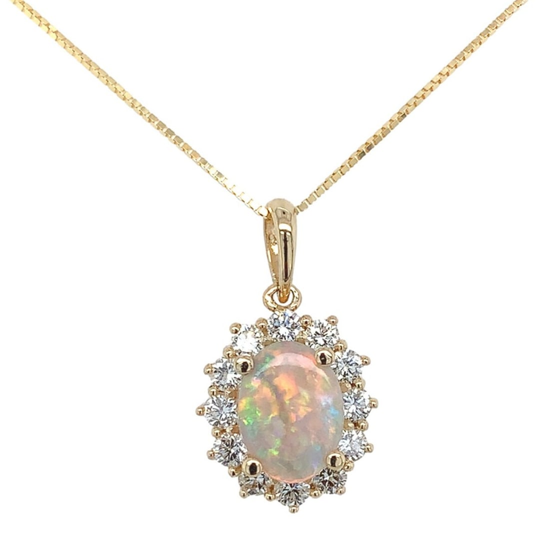 14k Yellow Gold .59ct Opal Pendant with Diamond Halo Necklace: 14k Yellow Gold .59ct Opal Pendant with Diamond Halo Necklace This exquisite pendant necklace features a stunning 14k yellow gold setting adorned with a genuine Australian opal and a diamond halo. The