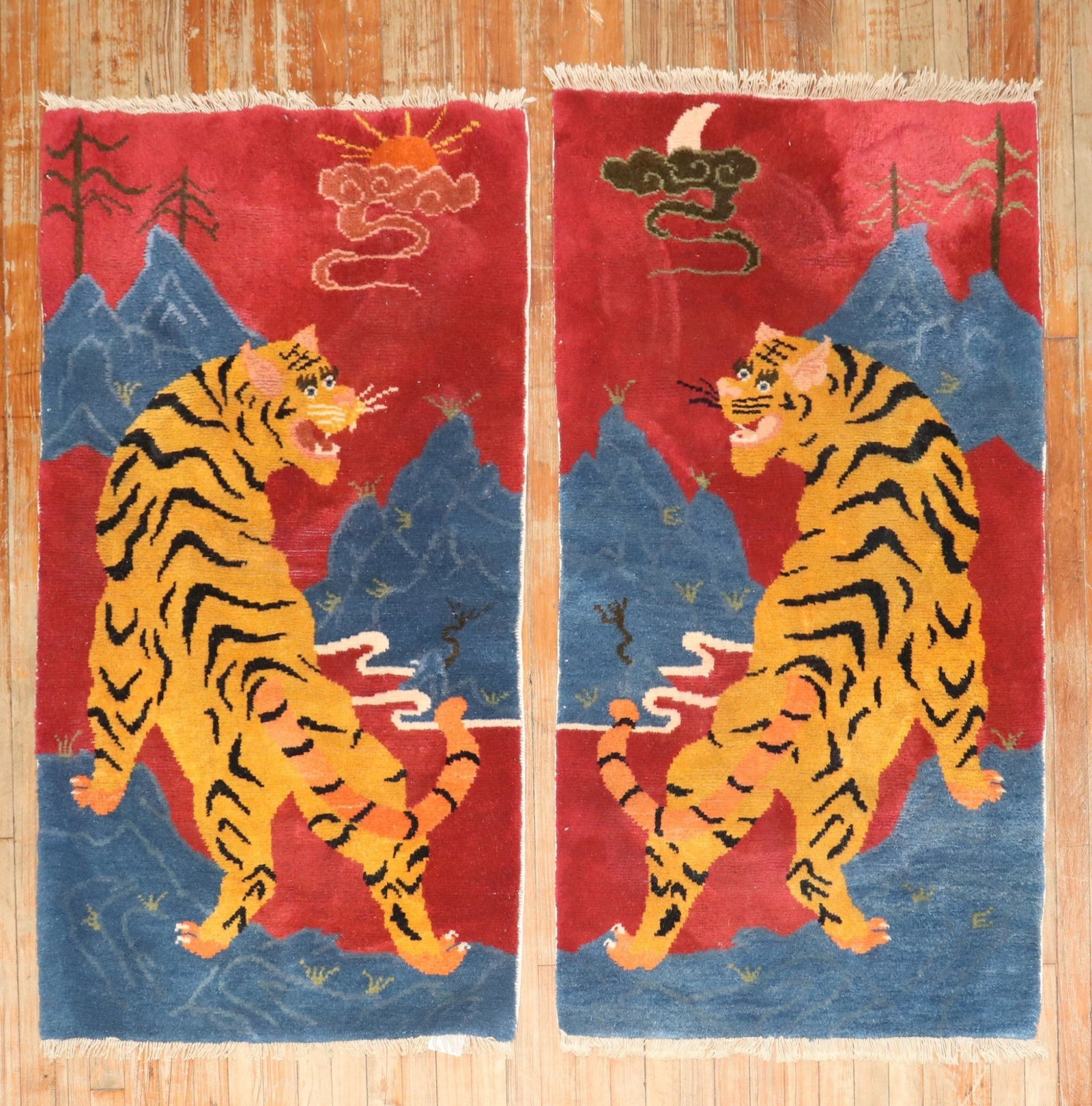 Pair of Tibetan pictorial tiger rugs 2' 8" x 4' 11": Pair of Tibetan pictorial tiger rugs 2' 8" x 4' 11" Rare pair of Tibetan pictorial rugs featuring tiger motifs. This pair dates to the 3rd quarter of the 20th century, with one rug showing a sun at th
