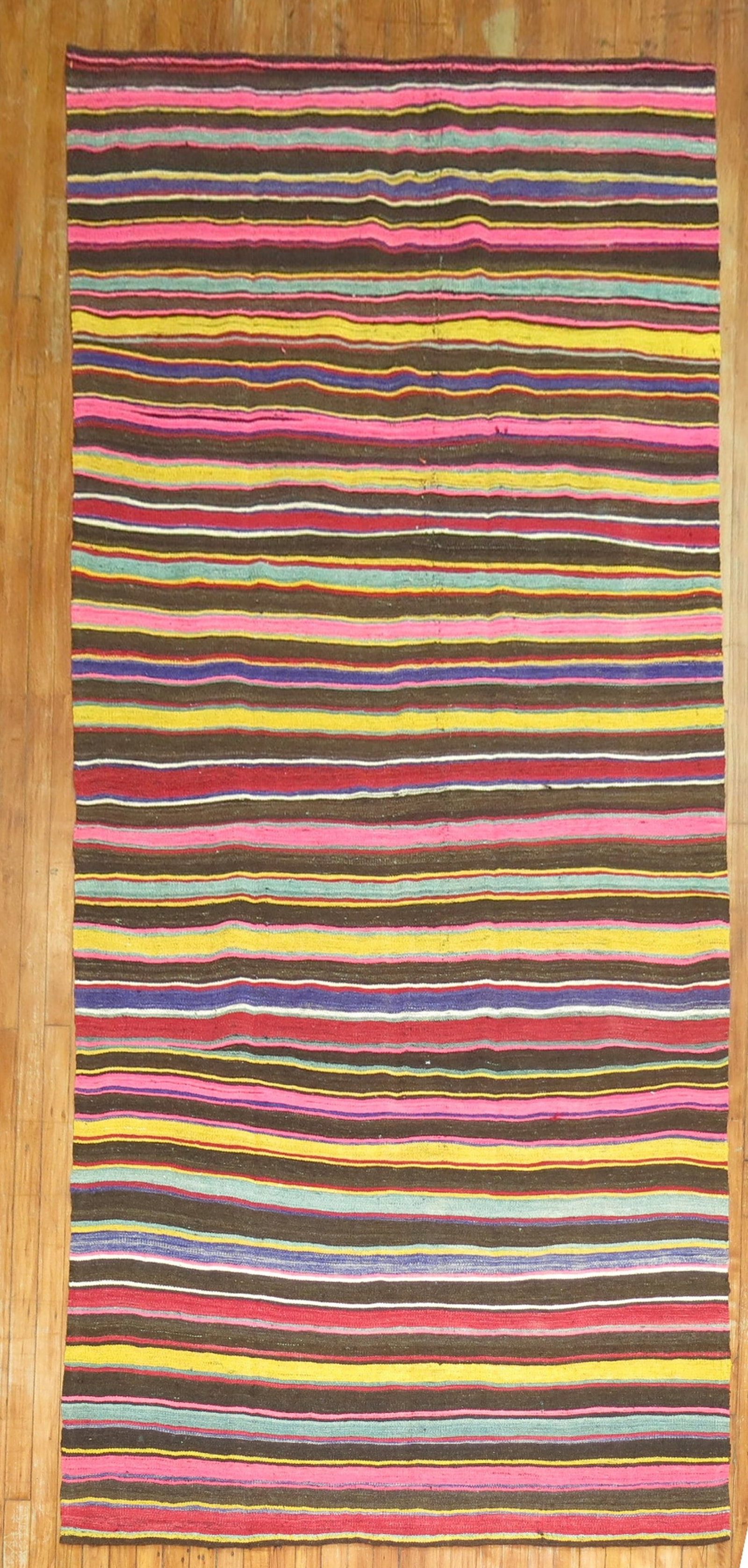 4' 9" x 10' 7" Turkish flatweave gallery kilim with stripes: 4' 9" x 10' 7" Turkish flatweave gallery kilim with stripes Mid 20th century Turkish gallery kilim with a striped flatweave design. This pre-owned piece features a colorful linear pattern and classic 