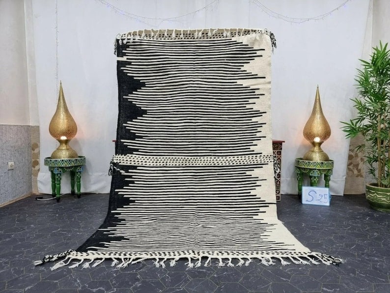 Handwoven Moroccan White Black Rug 3.28 x 6.56 Feet: Handwoven Moroccan White Black Rug 3.28 x 6.56 Feet Discover the beauty of the Elegant White & Black Rug, handwoven by skilled Berber women weavers in the Atlas Mountains of Morocco. This stunning pie
