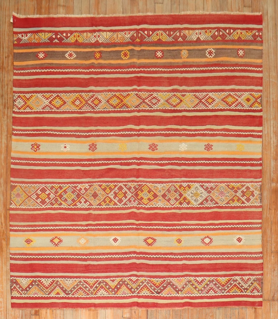 5' 10" x 6' 6" Anatolian striped kilim rug: 5' 10" x 6' 6" Anatolian striped kilim rug Mid-20th century Turkish square kilim with a striped Anatolian design. This pre-owned woven rug features geometric patterning in red, yellow, and beige tones