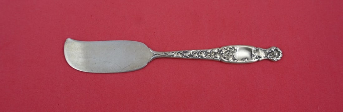 Whiting Heraldic Sterling Silver Butter Spreader 5 5/8 Inch: Whiting Heraldic Sterling Silver Butter Spreader 5 5/8 Inch This exquisite butter spreader is crafted from sterling silver and features a flat handle design in the classic Heraldic pattern by Whiting.