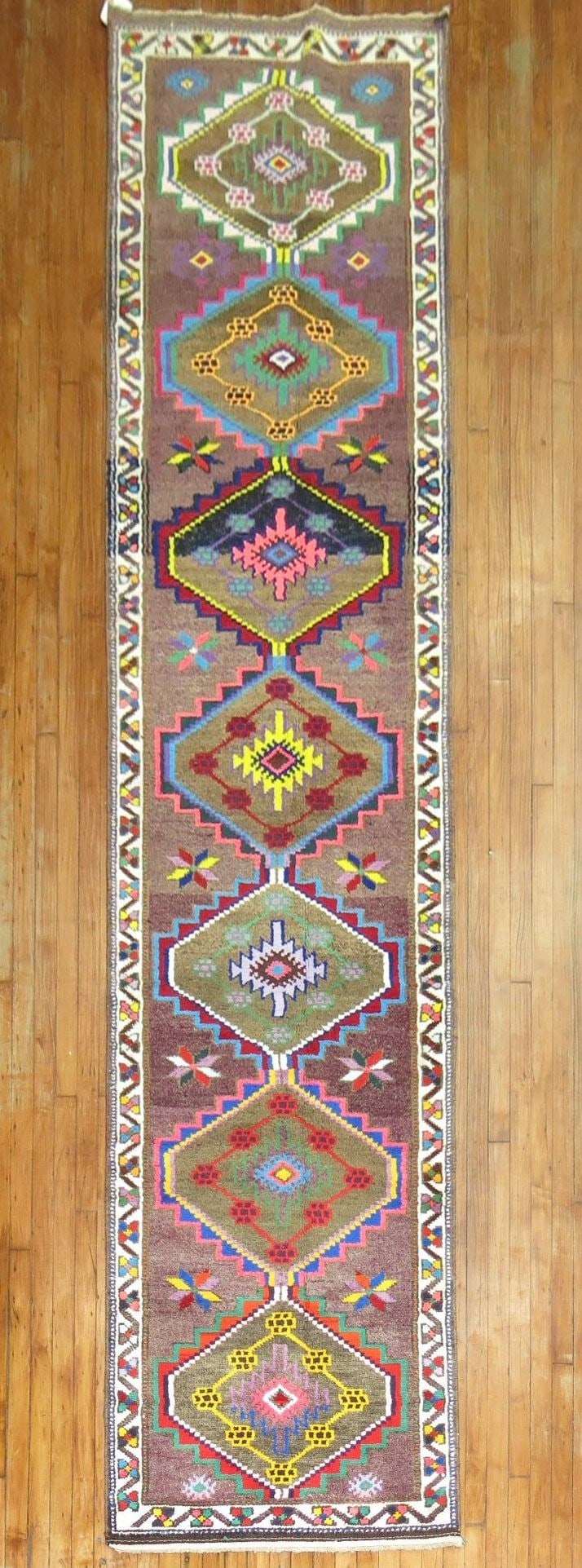 3' x 13' 10" Mid 20th Century Turkish Anatolian Runner Rug: 3' x 13' 10" Mid 20th Century Turkish Anatolian Runner Rug Mid-20th century Anatolian Turkish runner with a colorful geometric design. This pre-owned rug is presented in a long runner format and featu