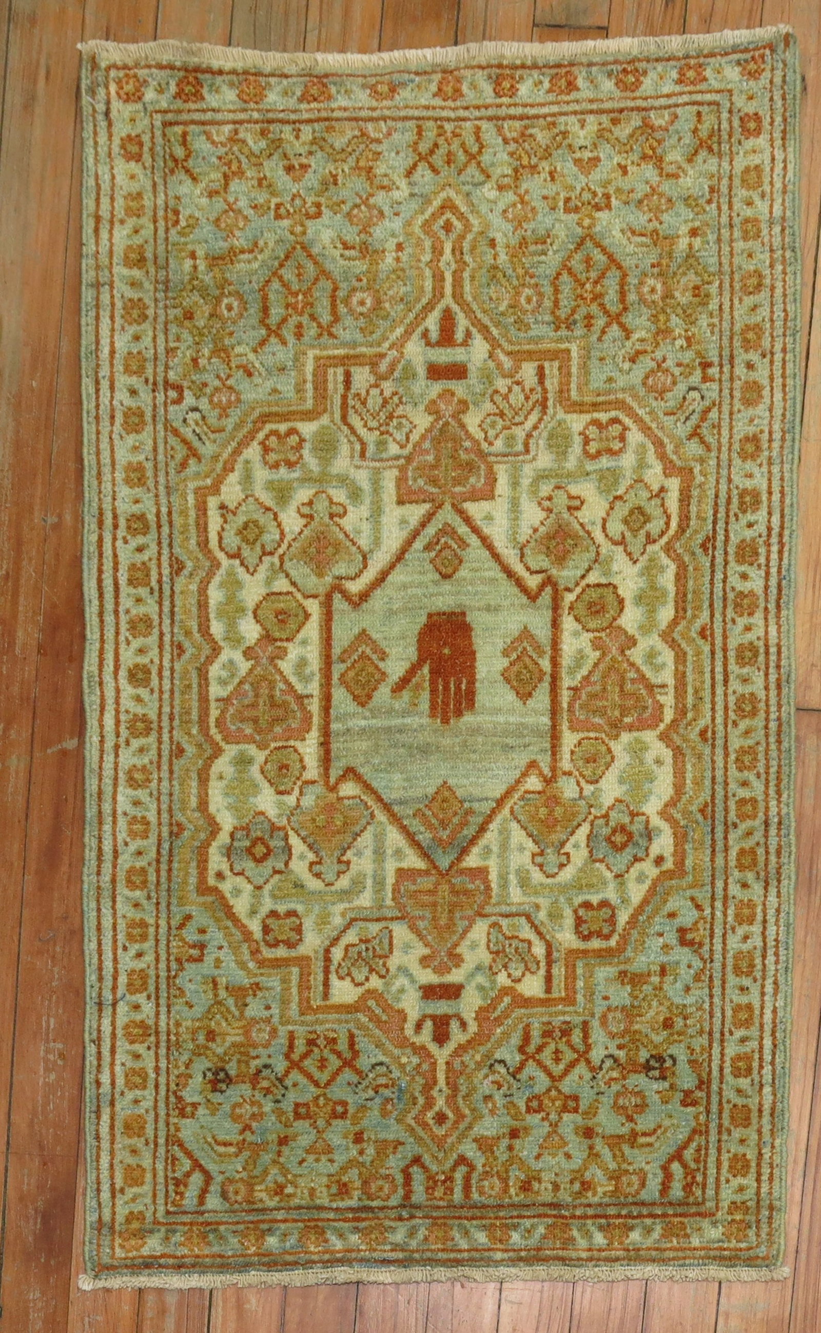 1' 10" x 3' Antique Persian Senneh Yastik Mat Hand Motif: 1' 10" x 3' Antique Persian Senneh Yastik Mat Hand Motif Early 20th century antique Persian Senneh mat with a small hand motif inside a blue-green medallion. The design features blue, green, rust, and