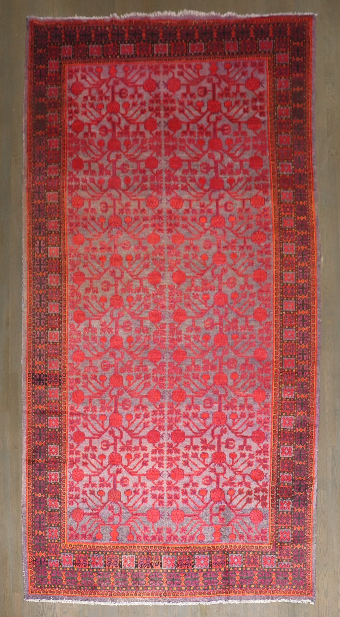 5' 9" x 11' 2" Khotan Gallery Rug with Colorful Pomegranate Design: 5' 9" x 11' 2" Khotan Gallery Rug with Colorful Pomegranate Design A colorful Khotan gallery rug from the 2nd quarter of the 20th century, featuring a pomegranate motif. This pre-owned piece offers a 