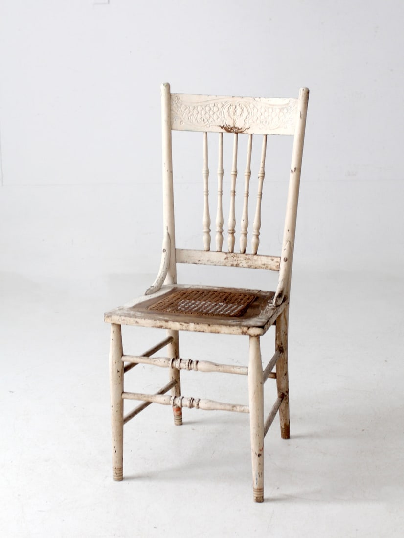 Antique Cream Painted Press Back Chair with Cane Seat: Antique Cream Painted Press Back Chair with Cane Seat This antique painted press back chair showcases a charming, softly worn cream-painted finish that adds a touch of warm, timeworn character. It fea