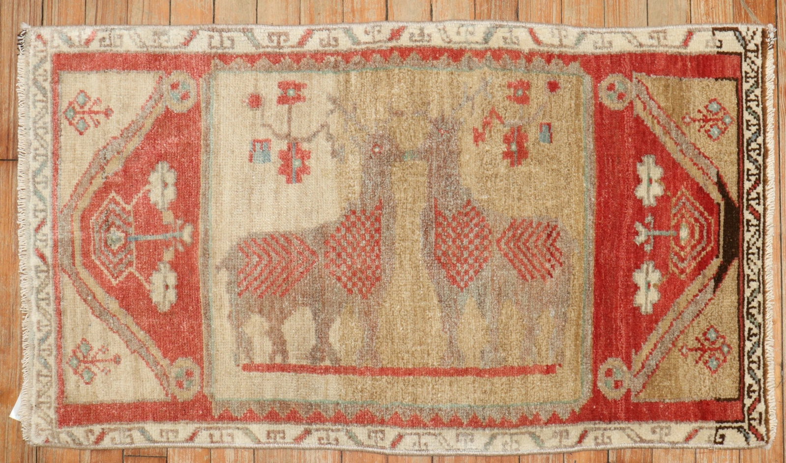 1' 10" x 3' 2" Turkish Anatolian Yastik Pictorial Rug with 2 Deer: 1' 10" x 3' 2" Turkish Anatolian Yastik Pictorial Rug with 2 Deer Mid-20th century Turkish Anatolian pictorial yastik rug featuring two deer on a camel field. This pre-owned mini rug presents a tradit