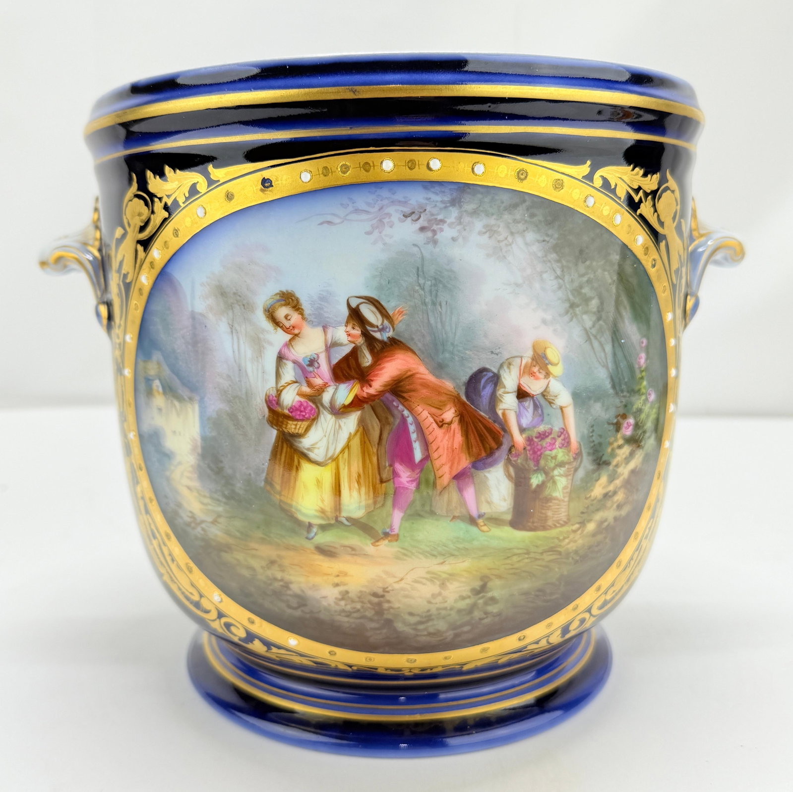 19th Century Sevres Cobalt Porcelain Hand Painted Jardiniere France: 19th Century Sevres Cobalt Porcelain Hand Painted Jardiniere France This exquisite 19th-century jardiniere, crafted by the renowned Sevres porcelain manufactory, showcases a stunning cobalt blue backg