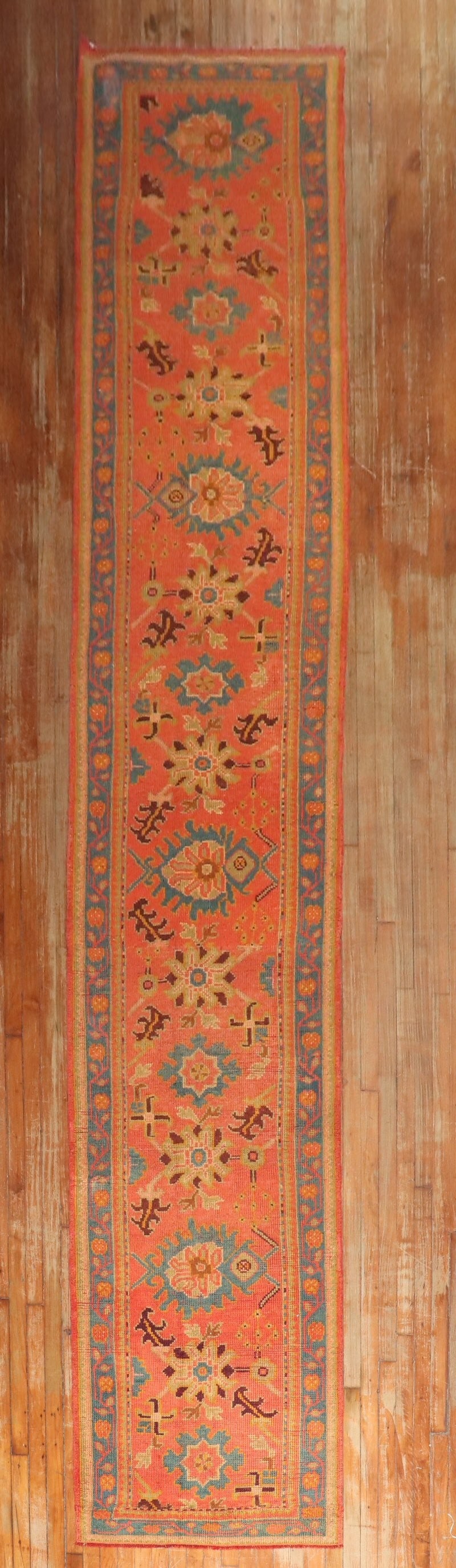 2' 11" x 18' 10" Antique Oushak Runner in Orange: 2' 11" x 18' 10" Antique Oushak Runner in Orange Early 20th century antique Oushak runner in a rare long size. This pre-owned piece features an orange field with intricate geometric patterning, offeri