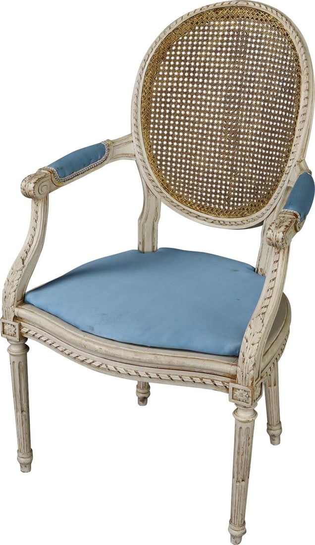 Antique 1900 French Louis XVI Cane Armchair with Blue Cushion: Antique 1900 French Louis XVI Cane Armchair with Blue Cushion This vintage 1900 French Louis XVI armchair features a classic design with a cane back and padded seat and arms, embodying the elegant sty
