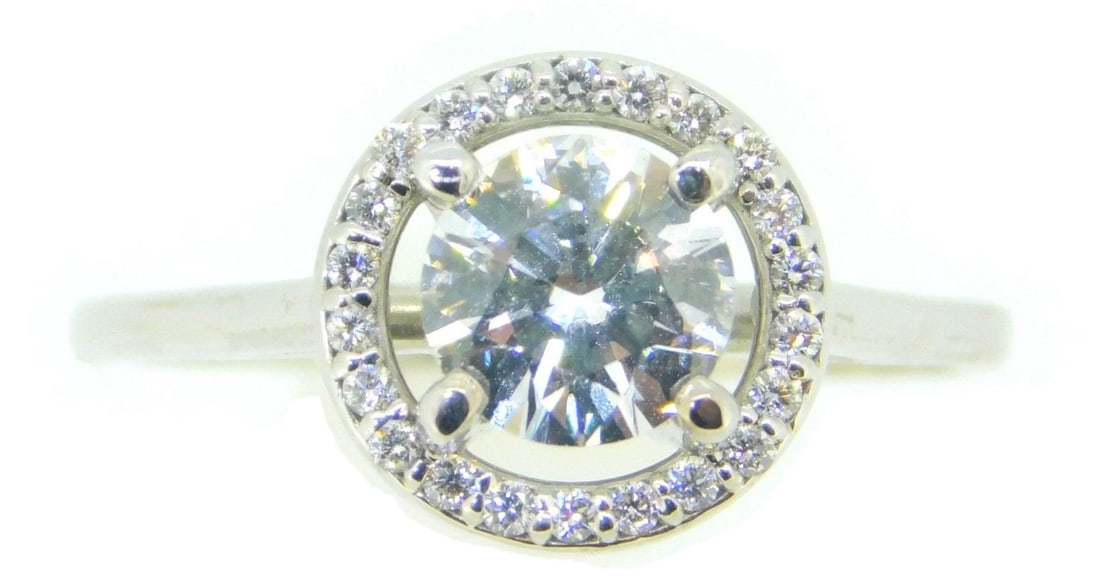 Stunning 14k White Gold .85ct Diamond Halo Ring: Stunning 14k White Gold .85ct Diamond Halo Ring This exquisite 14k White Gold ring showcases a stunning .85ct genuine natural diamond at its center, surrounded by a dazzling halo of smaller round diam