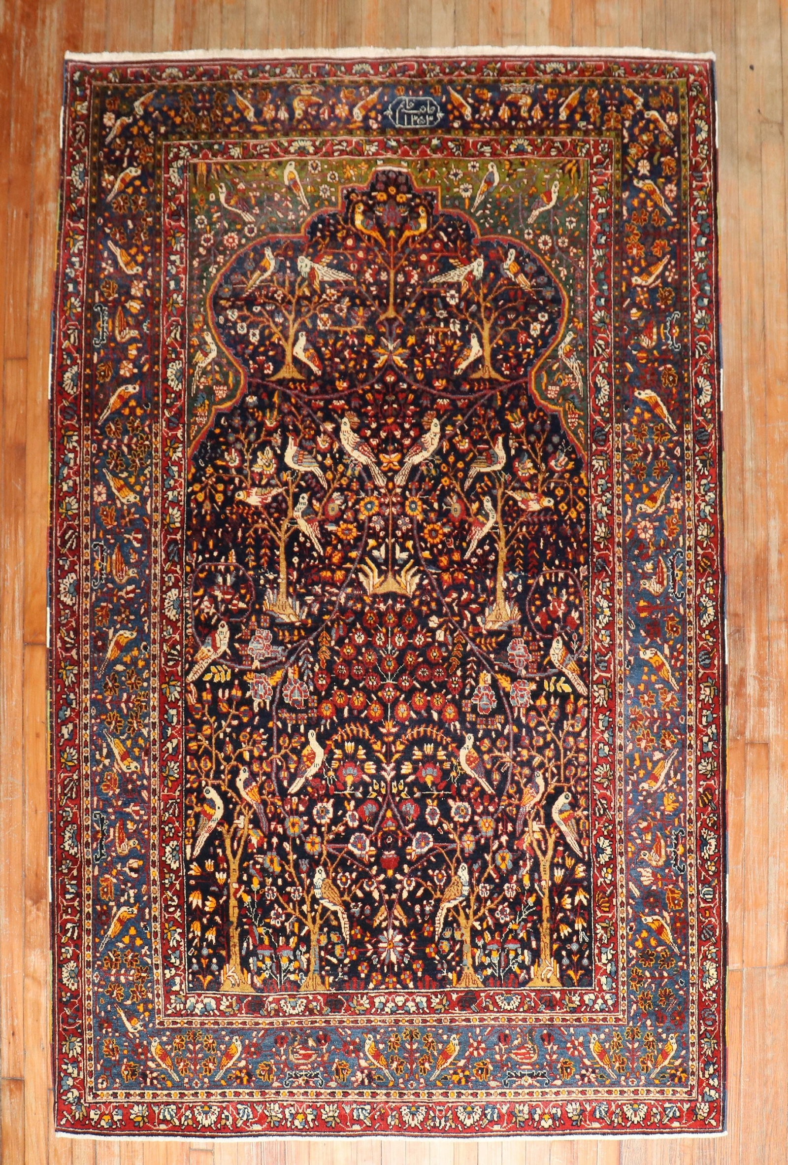 5' 6" x 8' 2" Persian pictorial prayer rug botanical motif: 5' 6" x 8' 2" Persian pictorial prayer rug botanical motif Early 20th century Persian rug featuring a botanical pictorial prayer motif. This pre-owned piece presents a decorative design consistent wit