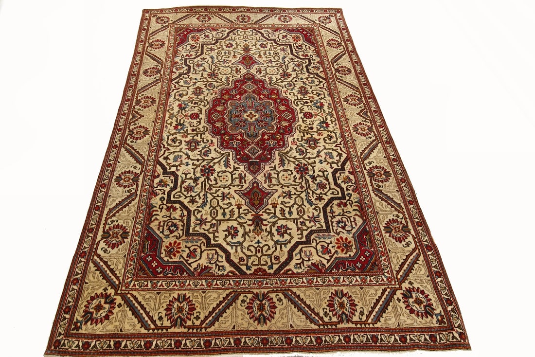 132 x 221 cm Hand Knotted Wool Afghan Medallion Rug c 1930: 132 x 221 cm Hand Knotted Wool Afghan Medallion Rug c 1930 Rare antique hand-knotted wool rug with a traditional geometric medallion design and floral motifs. The ivory field is accented by red, blue,
