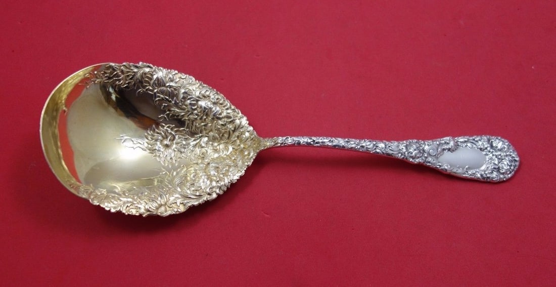 Durgin Chrysanthemum Sterling Silver Berry Spoon Gold Wash 9 1/4": Durgin Chrysanthemum Sterling Silver Berry Spoon Gold Wash 9 1/4" This exquisite serving spoon features the elegant Chrysanthemum pattern by Durgin, crafted from high-quality sterling silver with a be