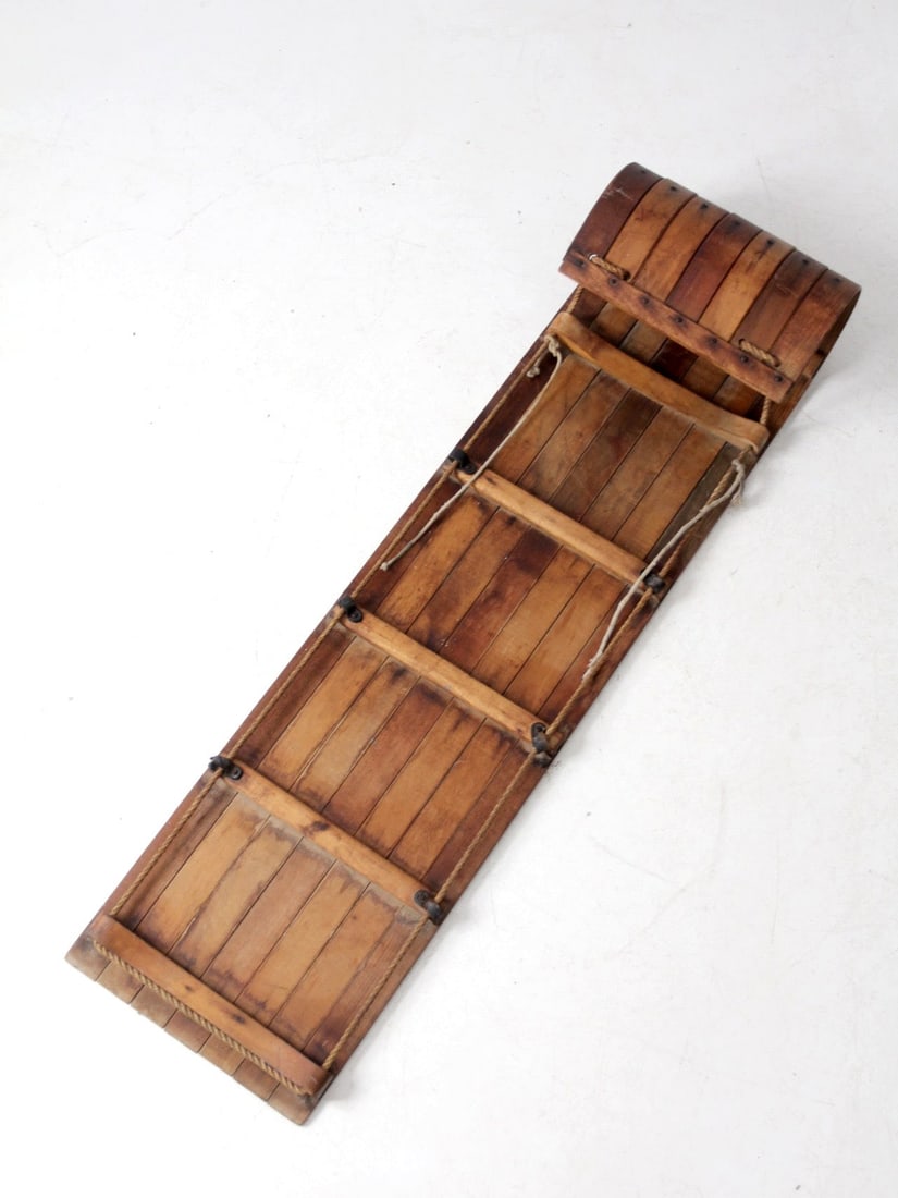 Mid-Century Wooden Toboggan 59 x 16 x 8.75 in Natural Finish: Mid-Century Wooden Toboggan 59 x 16 x 8.75 in Natural Finish This mid-century wooden toboggan showcases a warm, time-softened wood tone and an elegant, curled front, exuding a sculptural quality. Its 