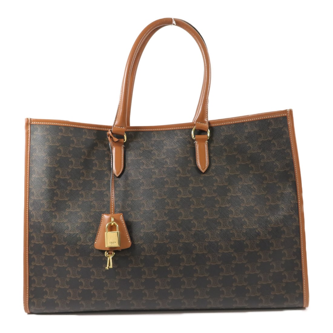 CELINE Horizontal Cabas Brown PVC Coated Canvas Tote Bag: CELINE Horizontal Cabas Brown PVC Coated Canvas Tote Bag CELINE horizontal Cabas tote bag in brown and tan PVC coated canvas. It features a hook button closure, one open interior pocket, one interior 