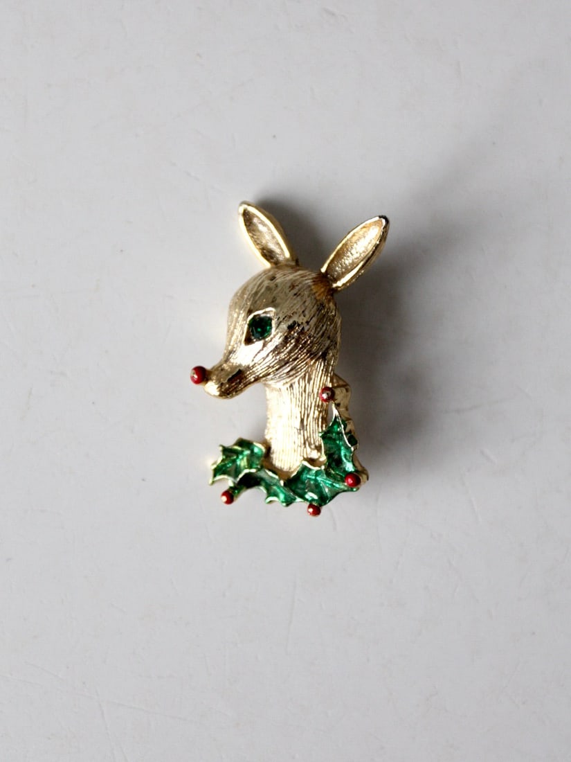 1960s Gerry's Christmas Reindeer Brooch Gold Tone Vintage: 1960s Gerry's Christmas Reindeer Brooch Gold Tone Vintage Celebrate the holiday spirit with this charming 1960s vintage Gerry's Creations Christmas reindeer brooch. Crafted in a gold tone, this brooch