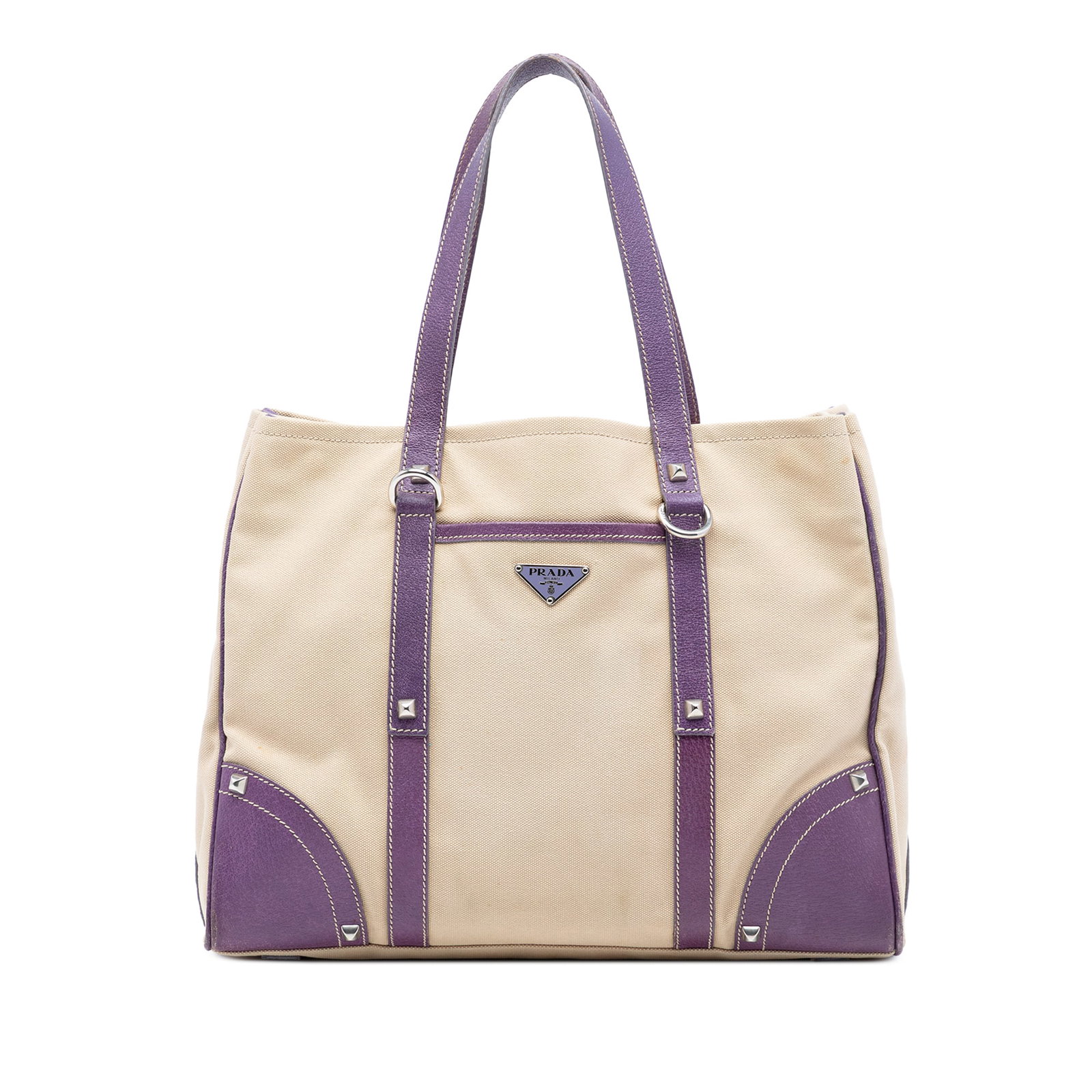 Prada Canvas Tote with Studded Leather Trim and Front Pocket: Prada Canvas Tote with Studded Leather Trim and Front Pocket This Prada tote bag features a brown canvas body with leather trim and studded embellishments. It is designed with flat leather handles, an