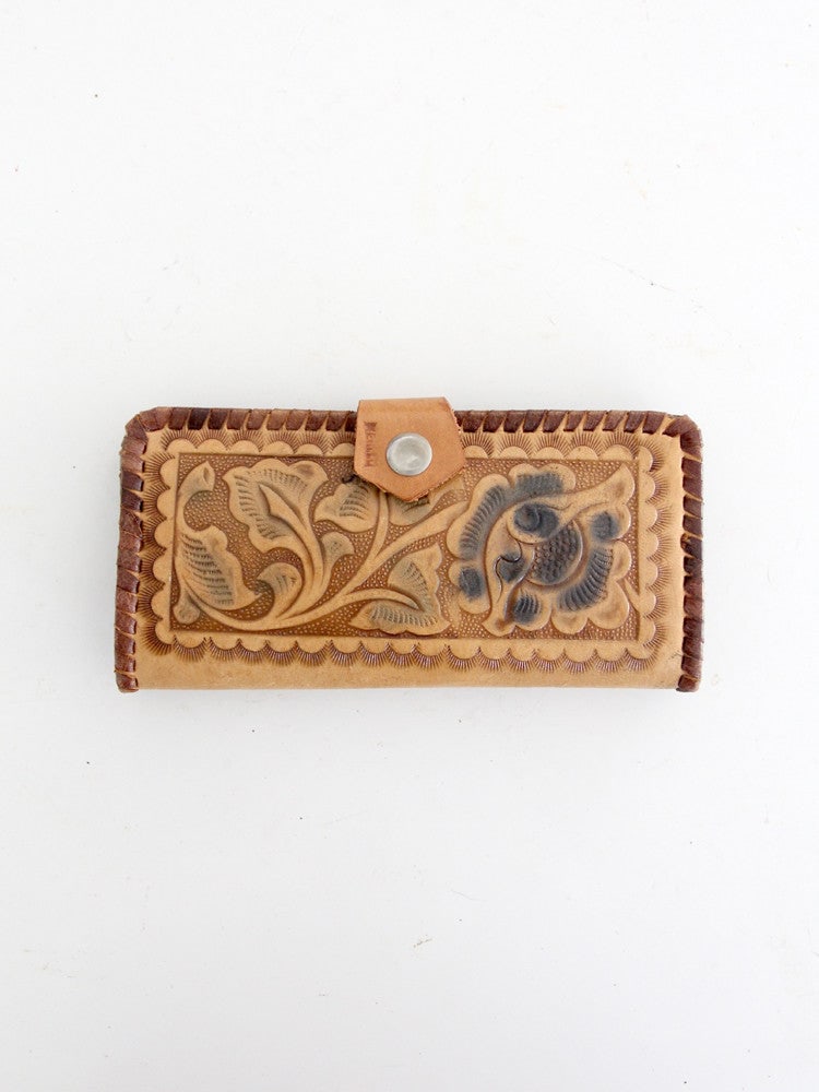 1970s Vintage Tooled Leather Bi-Fold Wallet with Floral Design: 1970s Vintage Tooled Leather Bi-Fold Wallet with Floral Design This vintage 1970s tooled leather wallet showcases a beautiful floral design, making it a unique accessory for any collection. The long t