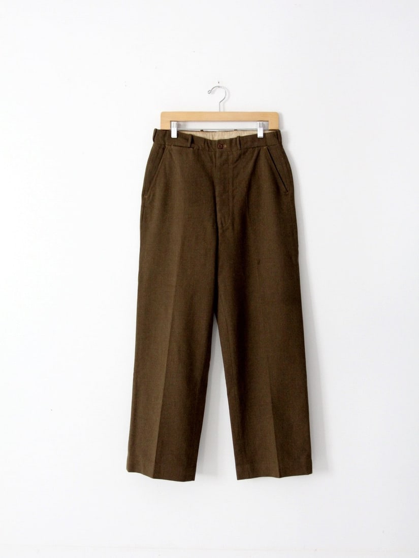 1950s Vintage US Army Olive Brown Wool Trousers with 4 Pockets: 1950s Vintage US Army Olive Brown Wool Trousers with 4 Pockets This pair of vintage American army trousers from the 1950s offers a classic military style in a rich olive brown wool. Designed with a hi
