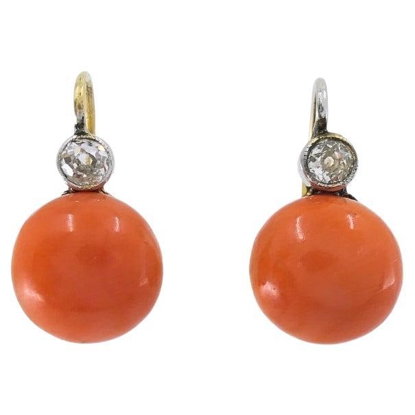 Victorian 14k Gold Lever Back Earrings with Coral and Diamond Drops: Victorian 14k Gold Lever Back Earrings with Coral and Diamond Drops Antique drop earrings crafted in 14k gold, featuring coral cabochons topped by diamond accents. They have a classic lever-back sleep