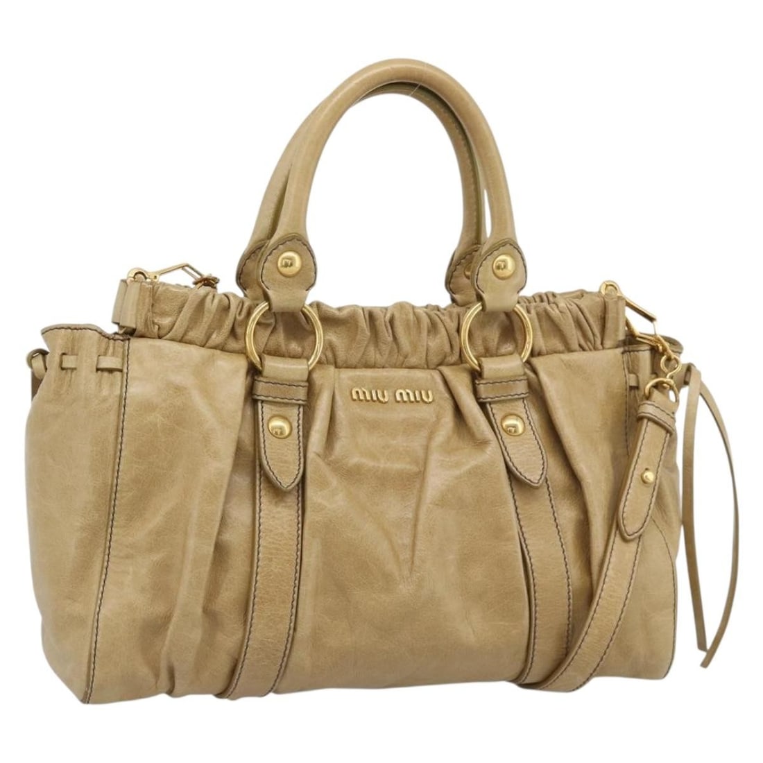 Miu Miu Beige Leather 2way Handbag with Strap Dust Bag: Miu Miu Beige Leather 2way Handbag with Strap Dust Bag Miu Miu 2-way handbag in beige leather with gold-tone accents. Made in Italy, this women's bag includes a dust bag and shoulder strap for hand ca