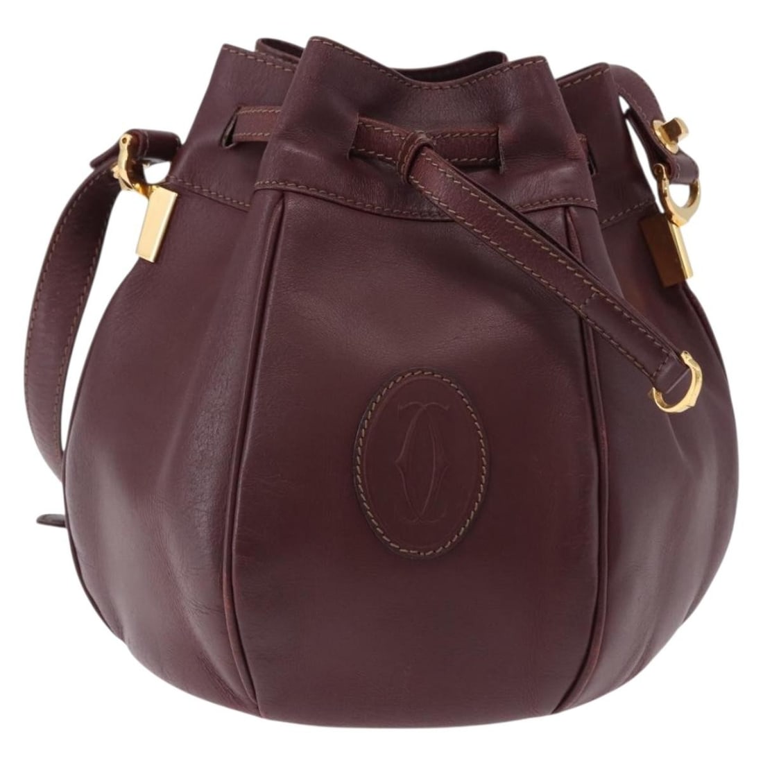 Cartier Must de Cartier burgundy leather shoulder bag: Cartier Must de Cartier burgundy leather shoulder bag Must de Cartier leather bag in burgundy with a fair overall condition. The exterior shows an out-of-shape form, light wear, slight cracking, light