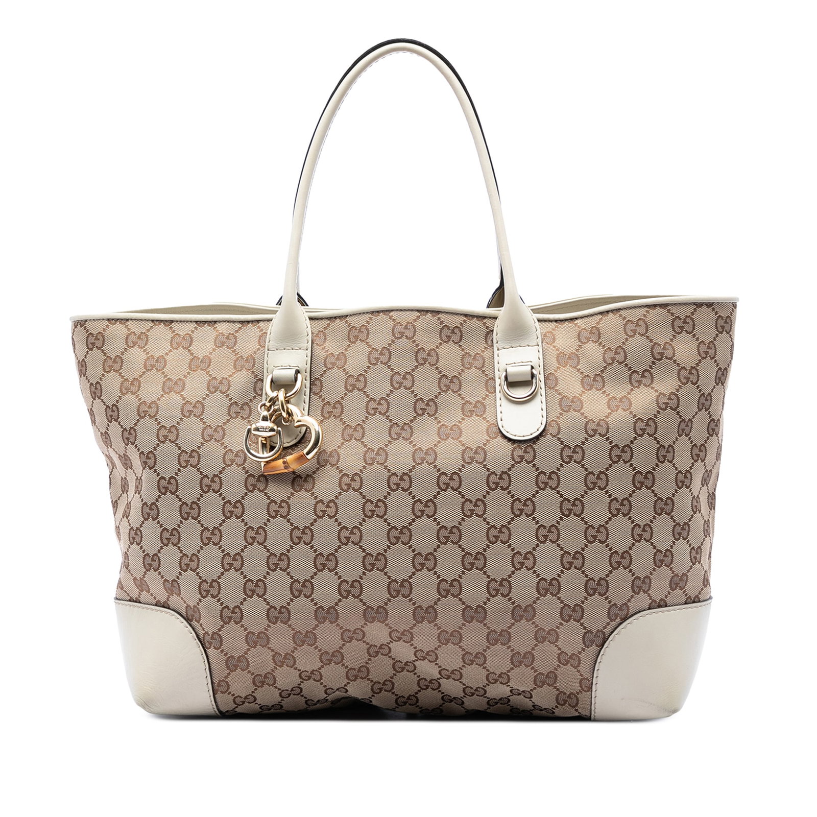 Gucci Heart Bit Tote Bag in GG Canvas with Leather Trim: Gucci Heart Bit Tote Bag in GG Canvas with Leather Trim Gucci GG Canvas Heart Bit Tote in beige canvas with leather trim and rolled leather straps. The bag features a metal heart charm, an open top wi