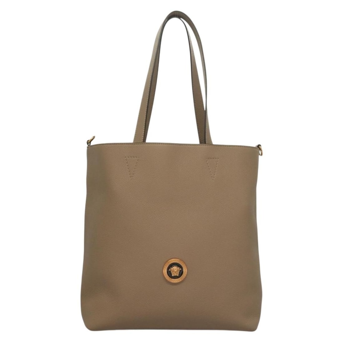 Beige La Medusa Tote by Versace Leather Italian Handbag: Beige La Medusa Tote by Versace Leather Italian Handbag The Versace La Medusa Tote is a sophisticated handbag crafted for women, featuring a beige leather exterior with an embossed canvas design. Made