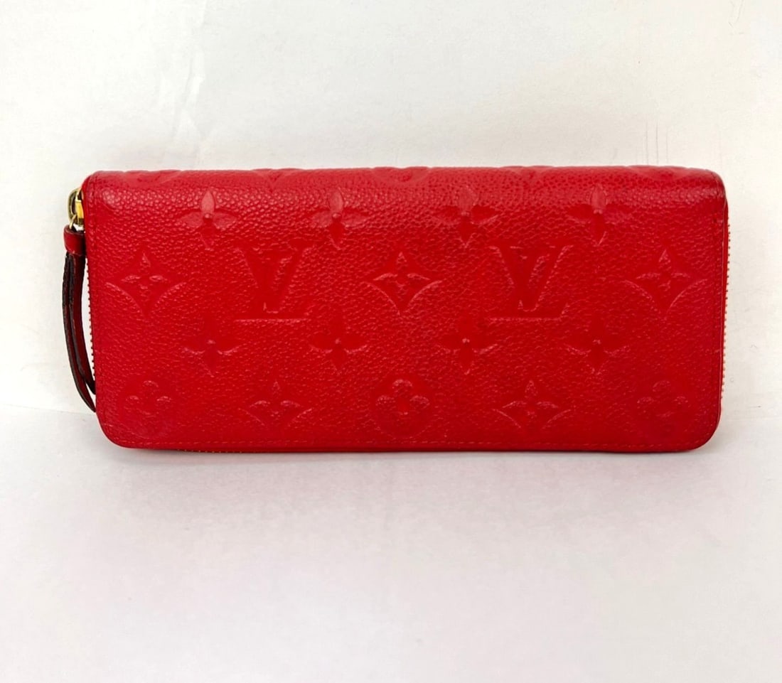 Louis Vuitton Clemence zip around wallet red leather: Louis Vuitton Clemence zip around wallet red leather A pre-owned Louis Vuitton Clemence wallet in red empreinte leather. This small zip-around wallet is designed for women and features a logo theme. M