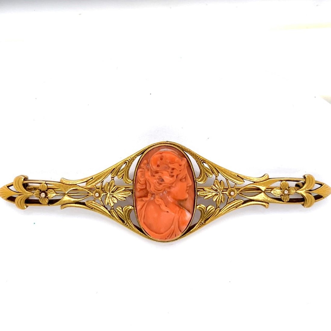 20K Yellow Gold and Coral Brooch from Art Nouveau Era: 20K Yellow Gold and Coral Brooch from Art Nouveau Era This Art Nouveau brooch is crafted from 20K yellow gold and features a coral accent. The brooch weighs 15.8 grams and measures 3.5 inches in lengt
