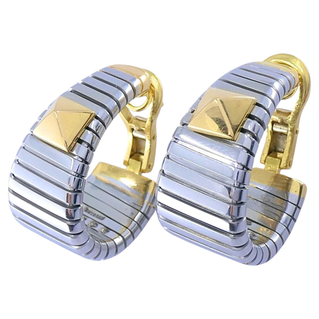 Bvlgari Tubogas Pyramid Hoop Earrings in 18k Gold and Steel: Bvlgari Tubogas Pyramid Hoop Earrings in 18k Gold and Steel Pair of Bvlgari Tubogas hoop earrings crafted in stainless steel with 18k yellow gold accents. The design features the brand's Tubogas const