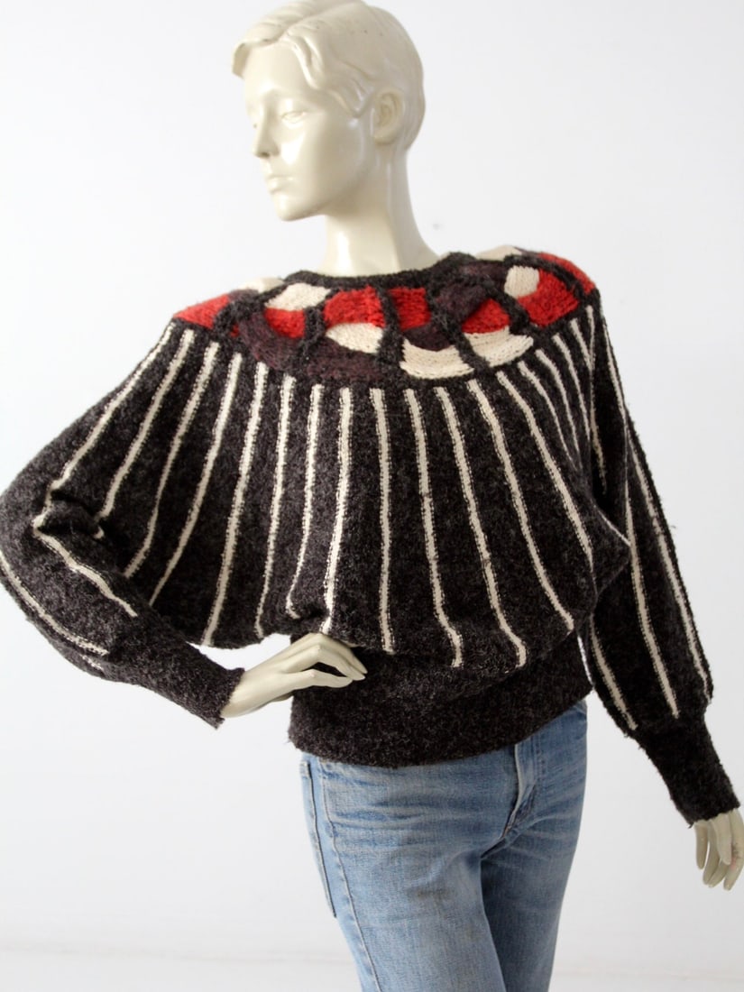 Mariea Kim Vintage 80s Butterfly Sleeve Black Knit Sweater: Mariea Kim Vintage 80s Butterfly Sleeve Black Knit Sweater This vintage sweater by Mariea Kim features stylish butterfly sleeves and dates back to the early 1980s. The chic black knit top is designed 