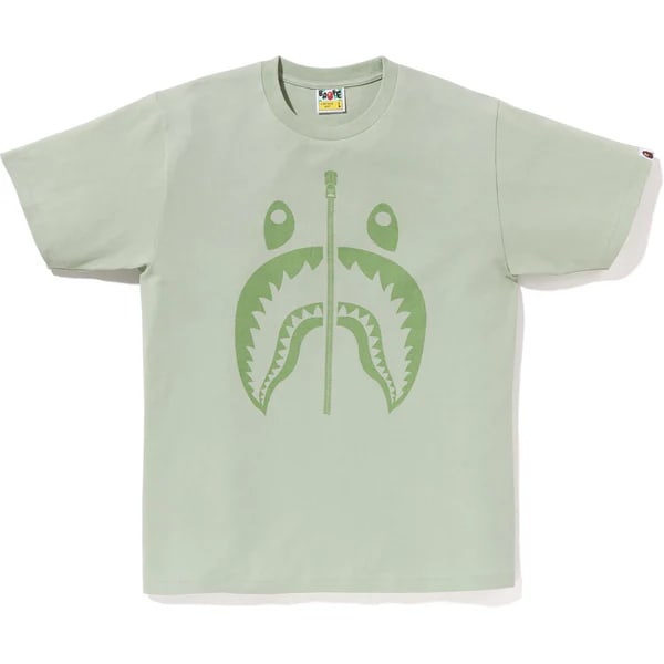 A Bathing Ape Pigment Shark Tee Green Cotton Medium: A Bathing Ape Pigment Shark Tee Green Cotton Medium A Bathing Ape Pigment Shark tee in green. This cotton T-shirt features a pigment-dyed finish for a vintage effect, the Shark graphic, a slightly ove