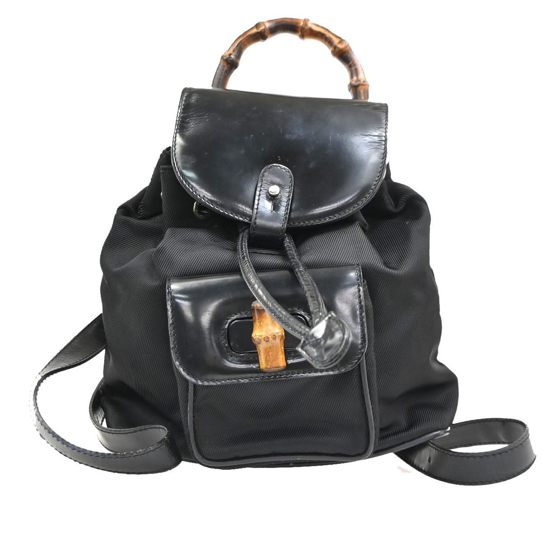 Gucci Vintage Bamboo Backpack Black Nylon and Patent Leather: Gucci Vintage Bamboo Backpack Black Nylon and Patent Leather This Gucci Vintage Bamboo Backpack is crafted from black nylon with patent leather accents. Designed for women, it features the iconic bamb