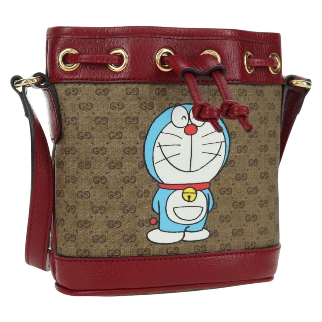 Doraemon Collaboration Beige Micro GG Supreme Shoulder Bag by Gucci: Doraemon Collaboration Beige Micro GG Supreme Shoulder Bag by Gucci This GUCCI x Doraemon Micro GG Supreme shoulder bag features beige and gold PVC leather with Micro Small GG canvas accents. The bag 