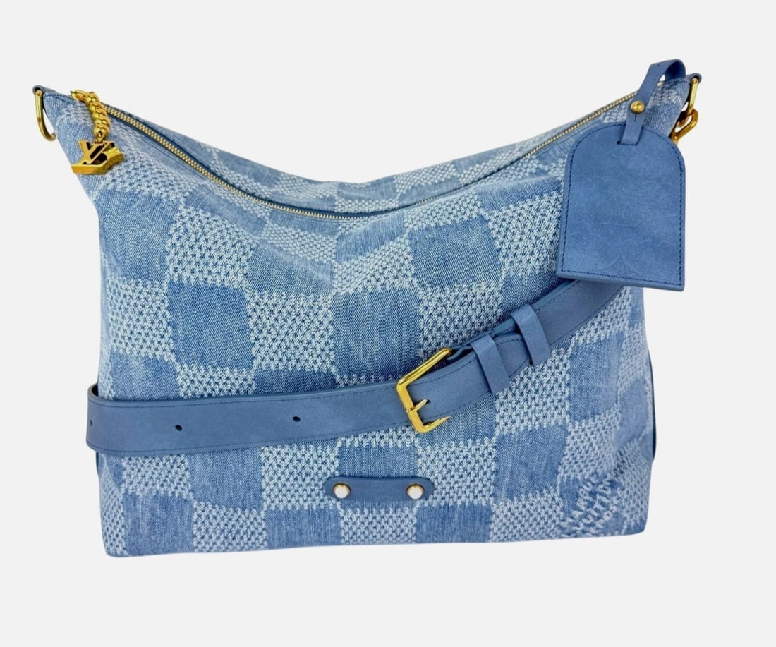 Damier Denim Vagabond Hobo Shoulder Bag by Louis Vuitton: Damier Denim Vagabond Hobo Shoulder Bag by Louis Vuitton The Louis Vuitton Damier Denim Vagabond hobo handbag features a large, rectangular silhouette crafted from blue denim with a checkered pattern 