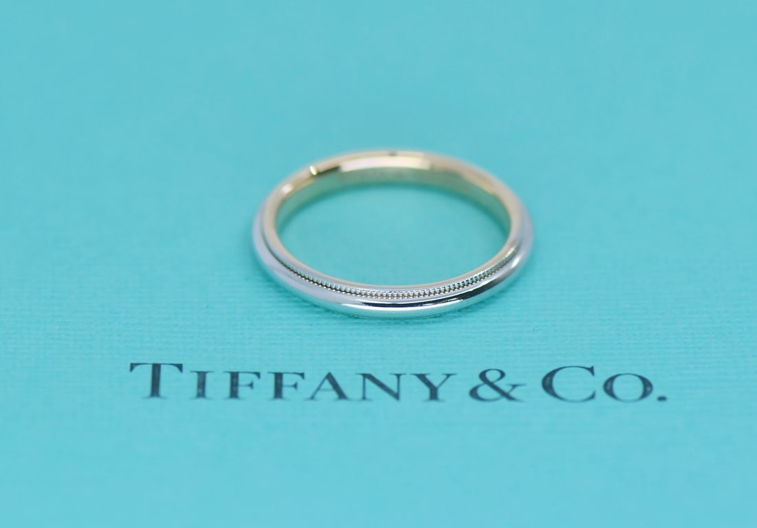 Milgrain Band in 18K Rose Gold and Platinum by Tiffany Size 8: Milgrain Band in 18K Rose Gold and Platinum by Tiffany Size 8 This Tiffany & Co. Milgrain ring features a classic design crafted in 18k rose gold and platinum. The band is 3mm wide and is a size 8. Th