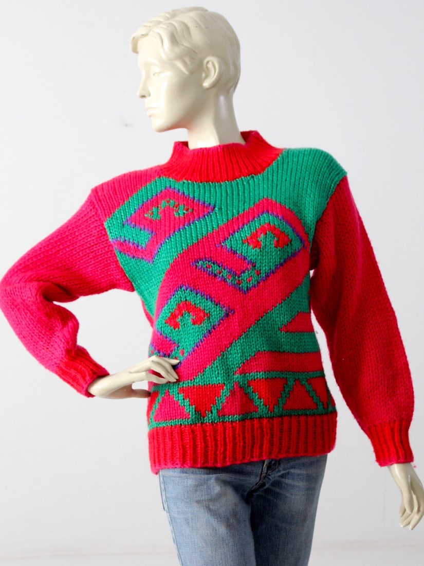 1980s Evian II Vintage Geometric Knit Sweater Magenta: 1980s Evian II Vintage Geometric Knit Sweater Magenta Step back in time with this authentic 1980s vintage knit sweater by Evian II. This vibrant magenta piece showcases a stunning geometric print in r