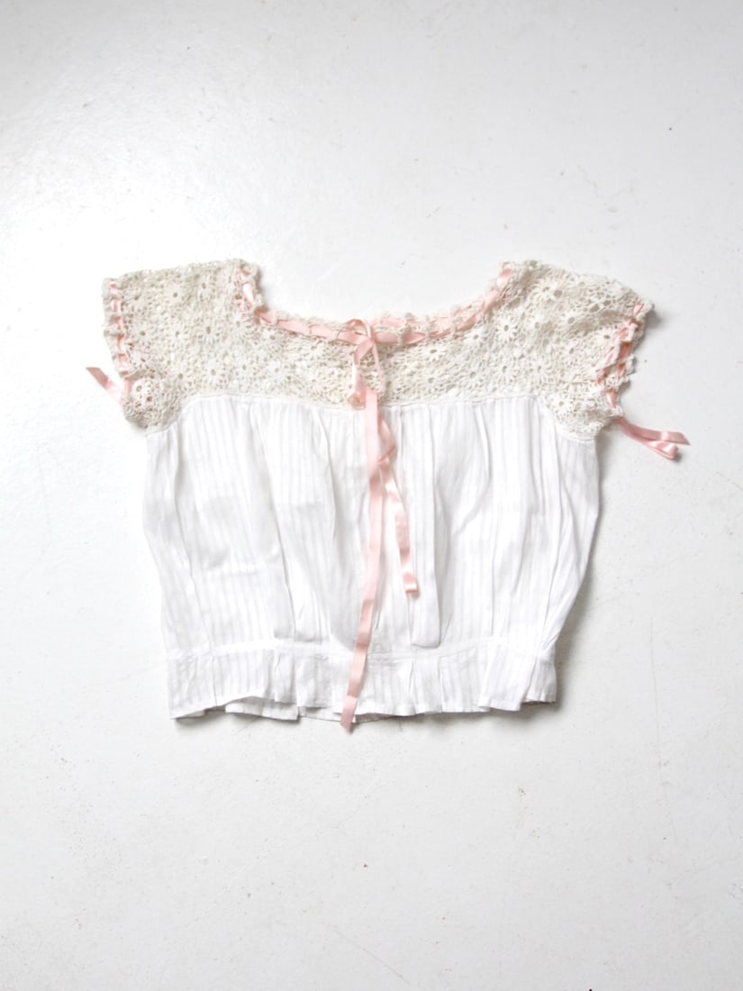 Antique Victorian Cotton Camisole Blouse with Crochet Lace and Ribbon Ties: Antique Victorian Cotton Camisole Blouse with Crochet Lace and Ribbon Ties Discover the charm of the Victorian era with this exquisite antique camisole blouse. Crafted from soft white cotton, it showc