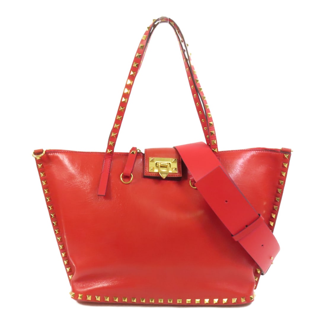 Valentino red calfskin 2 way shoulder bag with strap: Valentino red calfskin 2 way shoulder bag with strap Valentino 2-way shoulder bag in red calfskin leather with a structured design and gold-tone hardware. The bag features an interior with one zip poc