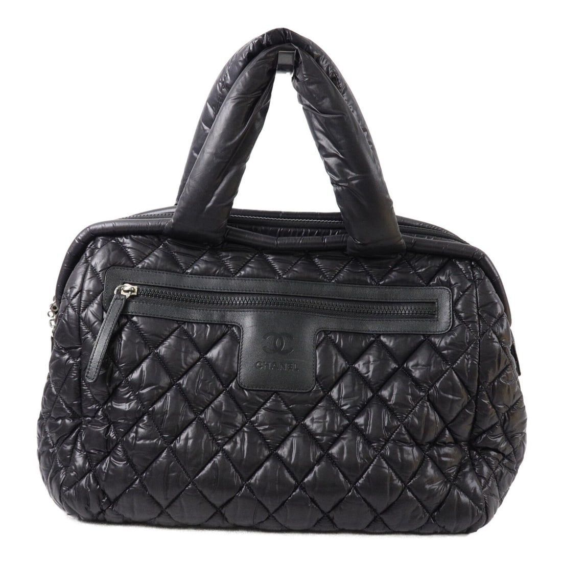 CHANEL Cocoon CC Nylon Tote Handbag Black: CHANEL Cocoon CC Nylon Tote Handbag Black CHANEL CC Cocoon tote bag in black nylon with a black exterior. This women's handbag features a structured tote silhouette with zip pockets inside and out. In