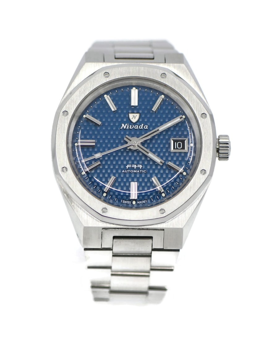 Nivada Grenchen F77 automatic wristwatch blue dial steel bracelet: Nivada Grenchen F77 automatic wristwatch blue dial steel bracelet Pre-owned Nivada Grenchen F77 wristwatch with a stainless steel case and bracelet, blue analog dial, and automatic mechanical movement