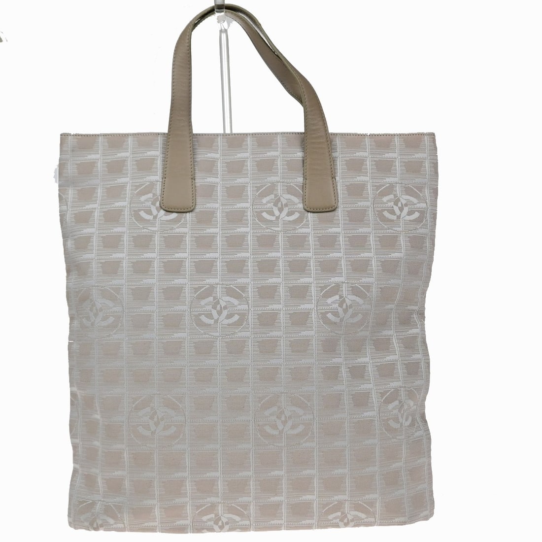 Chanel Travel Line Nylon Tote Bag Beige: Chanel Travel Line Nylon Tote Bag Beige Chanel Travel Line Tote in beige nylon. This women's tote is made in Italy and is presented in good condition, with light scuffing, dirt, wrinkling, light stain