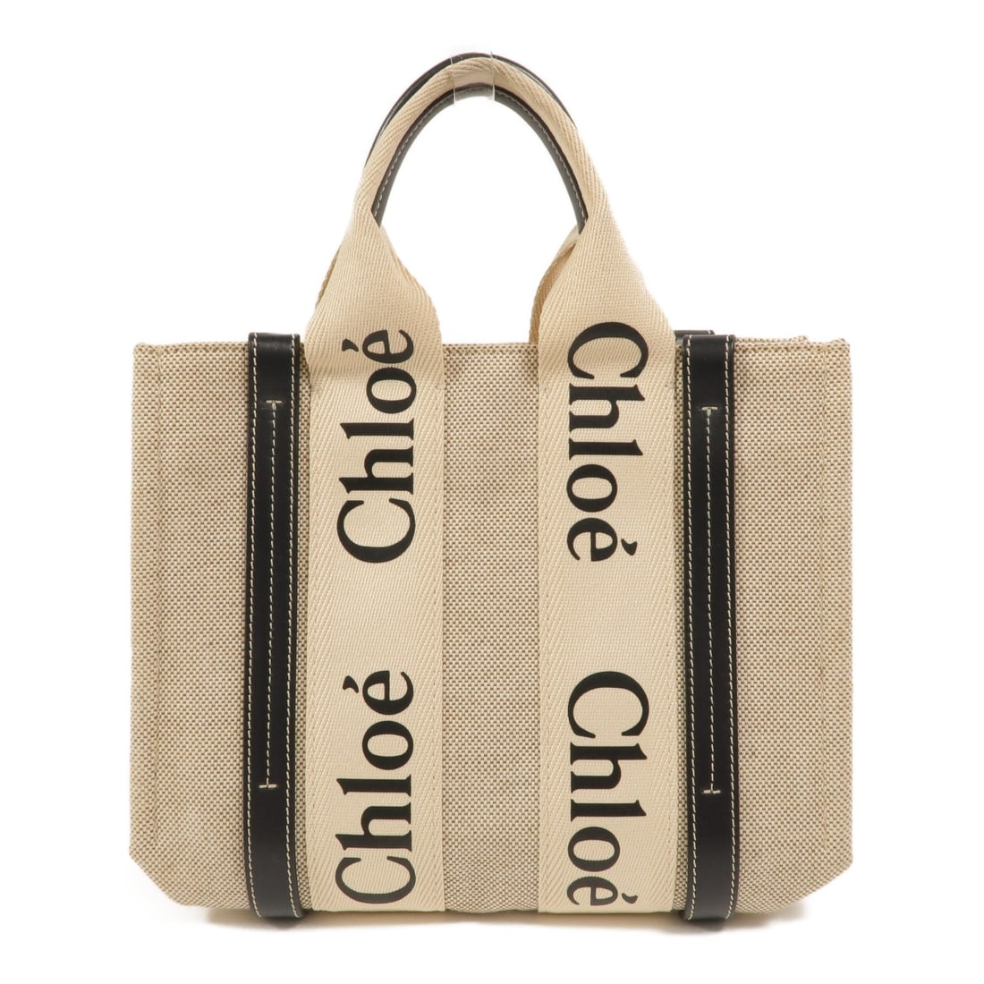 Chloe Woody canvas small tote handbag beige and black: Chloe Woody canvas small tote handbag beige and black Chloe Woody small tote bag in beige and black canvas. This women's tote features a compact silhouette with an open interior pocket and shows reaso