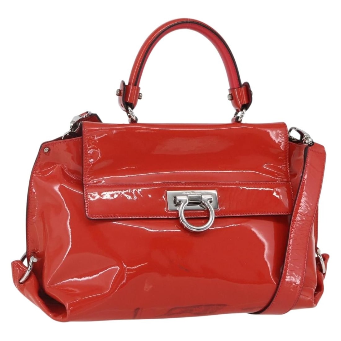 Salvatore Ferragamo Gancini Patent Leather Red Handbag 34x22x14cm: Salvatore Ferragamo Gancini Patent Leather Red Handbag 34x22x14cm This Salvatore Ferragamo Gancini handbag for women is crafted from red patent leather and features metal fittings. It displays signs o