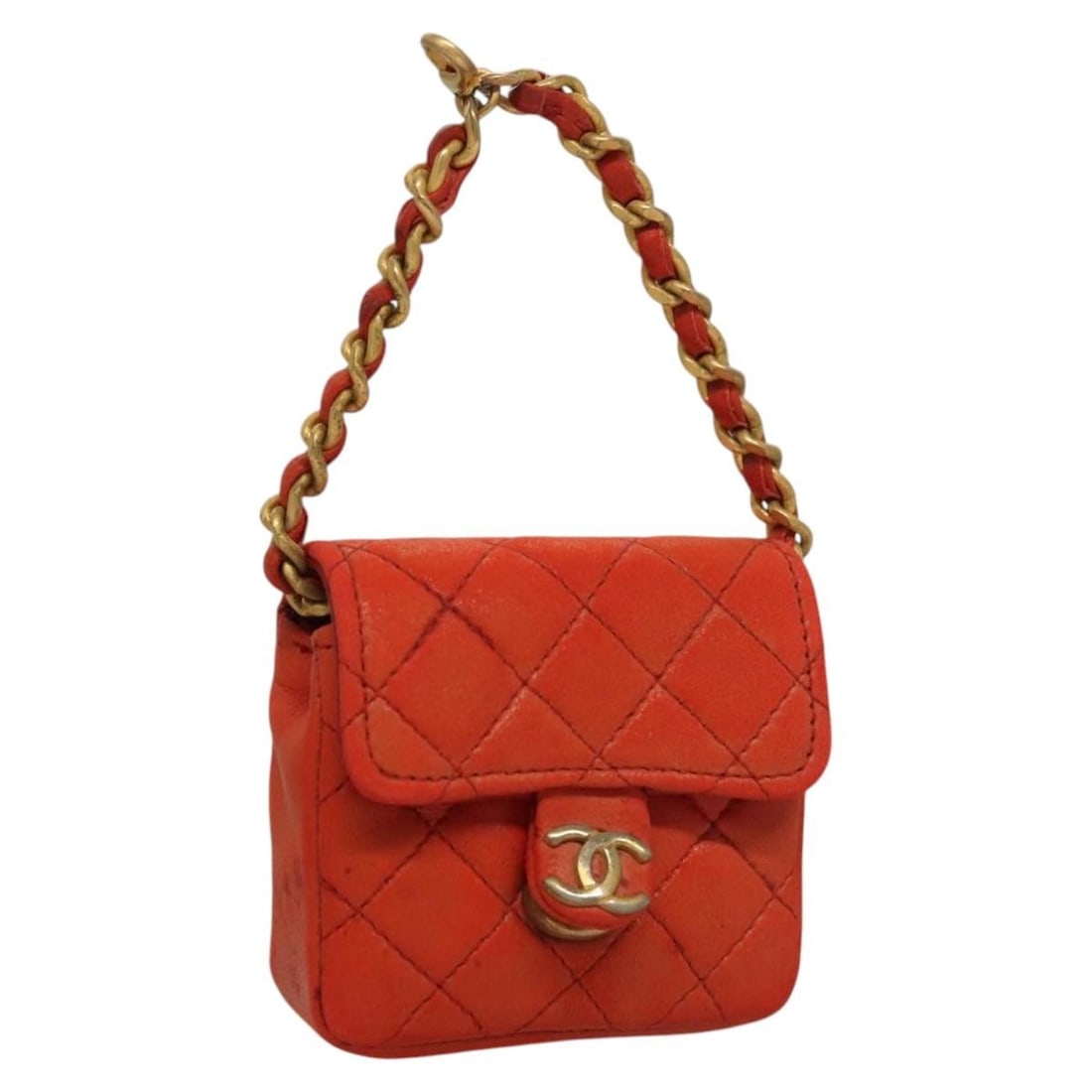 CHANEL Charm Mini Matelasse Orange Lamb Skin France: CHANEL Charm Mini Matelasse Orange Lamb Skin France Mini matelasse charm crafted in orange lamb skin. This women's accessory is made in France and shows heavy use, including rubbing, stains, slight lo